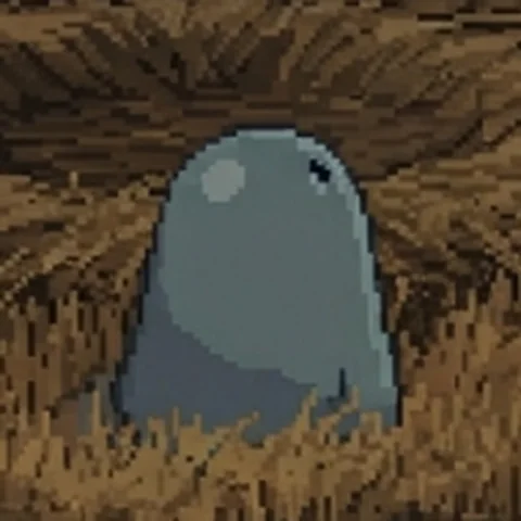Pixel-art close-up of a small, round, blue-gray creature peeking out of a grassy crater
